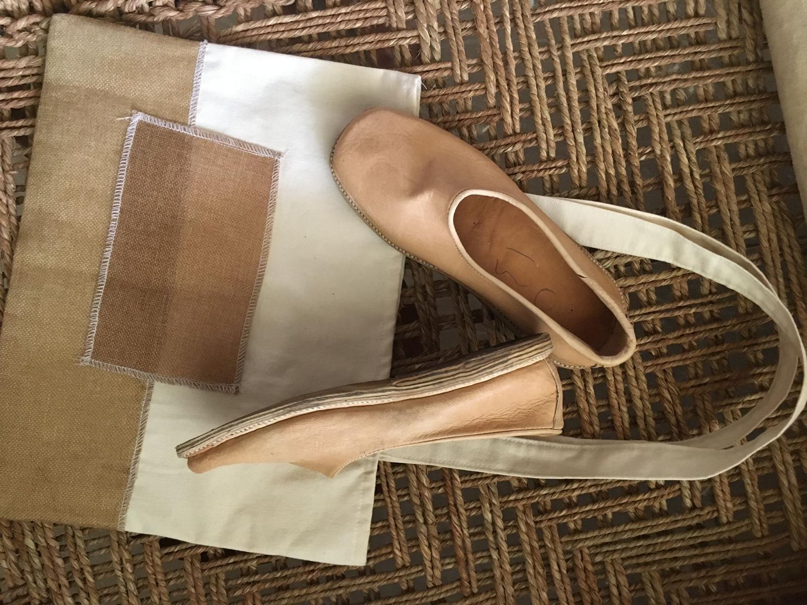 Original shoes and cloth bag on a woven surface